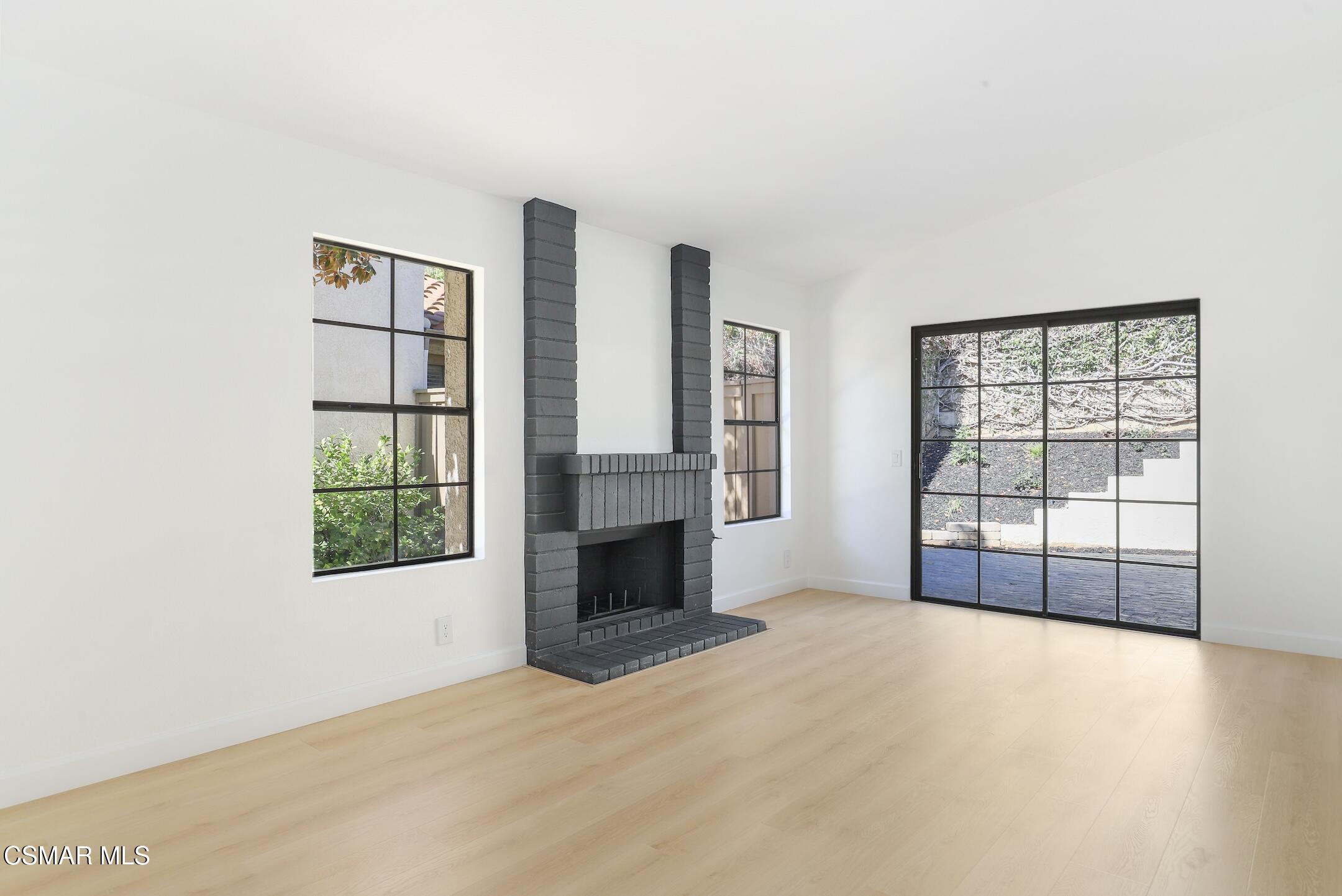 765 Congressional Road Simi Valley, CA 93065 - Photo 6 of 35 an empty room with windows and fireplace