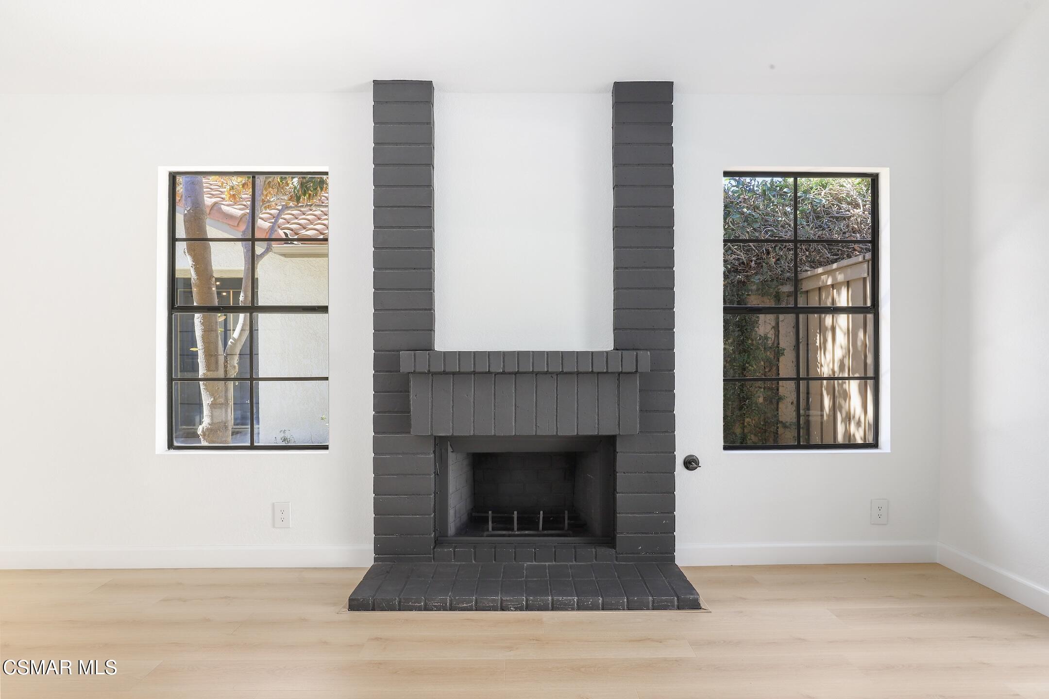 765 Congressional Road Simi Valley, CA 93065 - Photo 7 of 35 a living room with a fireplace and a window