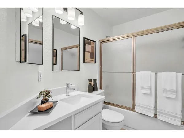 a bathroom with a shower and a sink