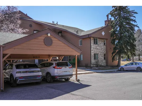 a view of house with outdoor space and car parked