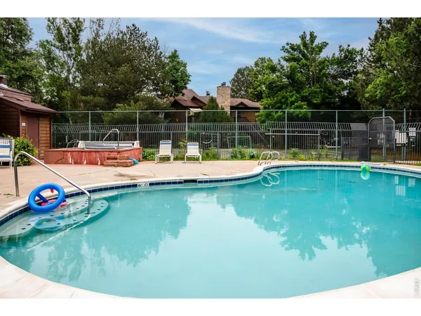 a small pool with lawn chairs