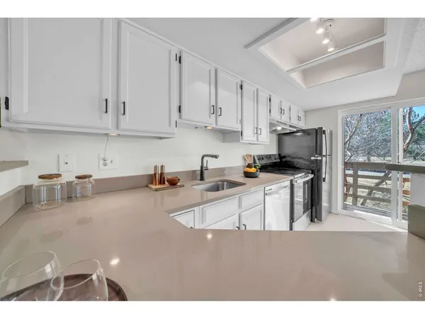 a kitchen with stainless steel appliances granite countertop a sink a stove and a granite counter tops
