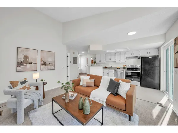 a kitchen with stainless steel appliances granite countertop a refrigerator sink and stove