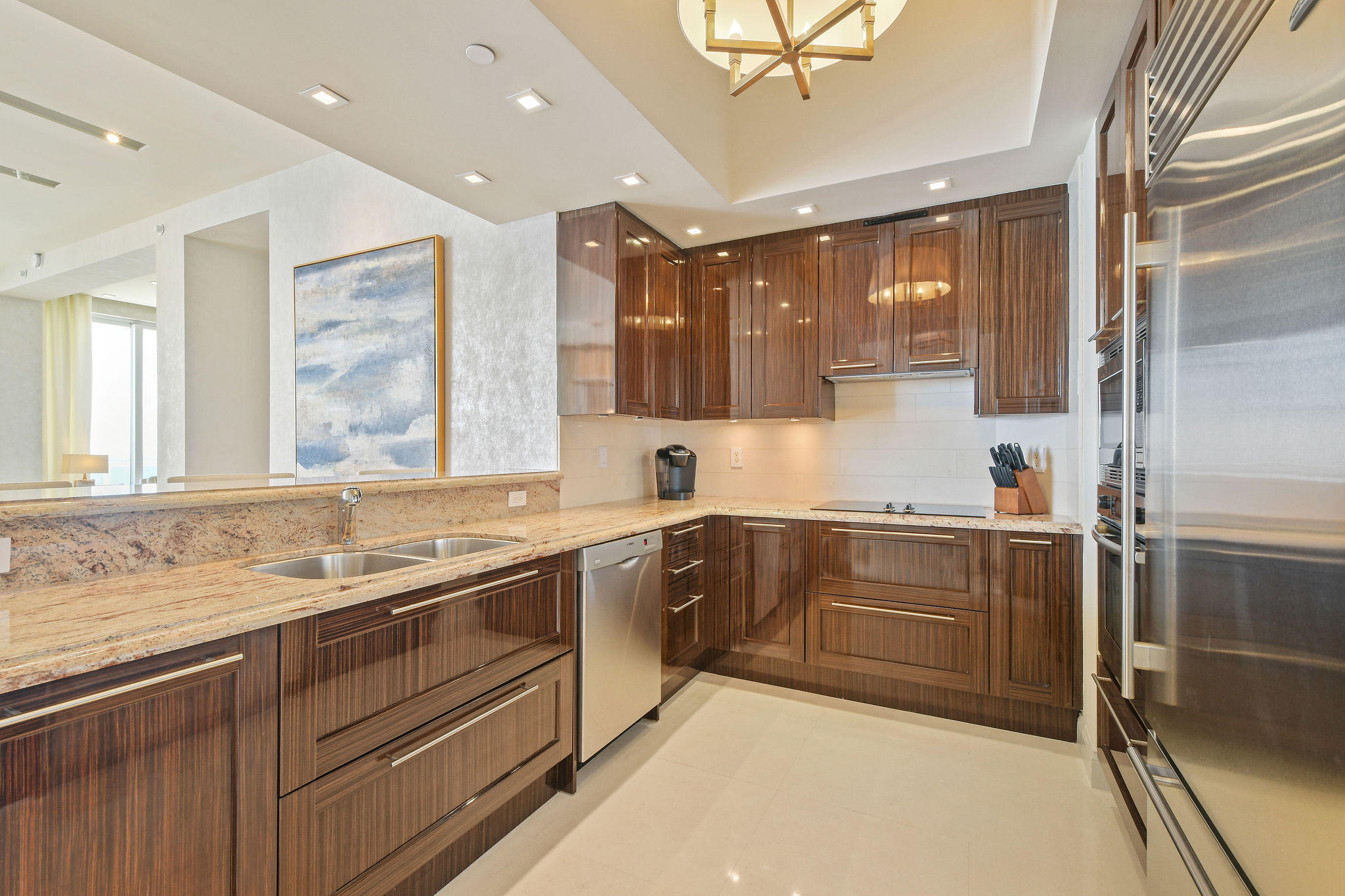 2700 North Ocean Drive, Unit LPH4B Riviera Beach, FL 33404 - Photo 12 of 67 a kitchen with a sink stove and cabinets