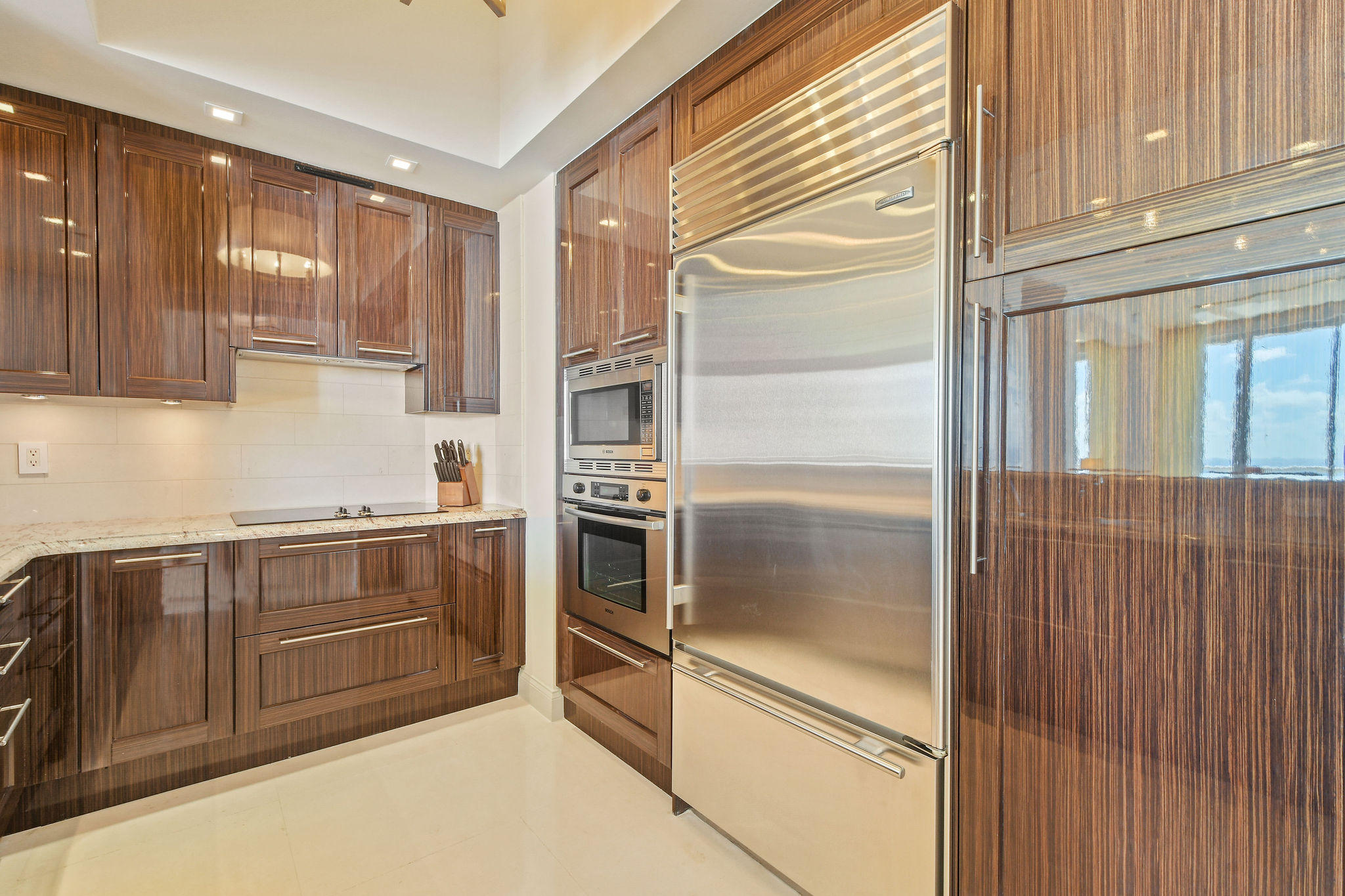 2700 North Ocean Drive, Unit LPH4B Riviera Beach, FL 33404 - Photo 13 of 67 a kitchen with granite countertop stainless steel appliances and cabinets