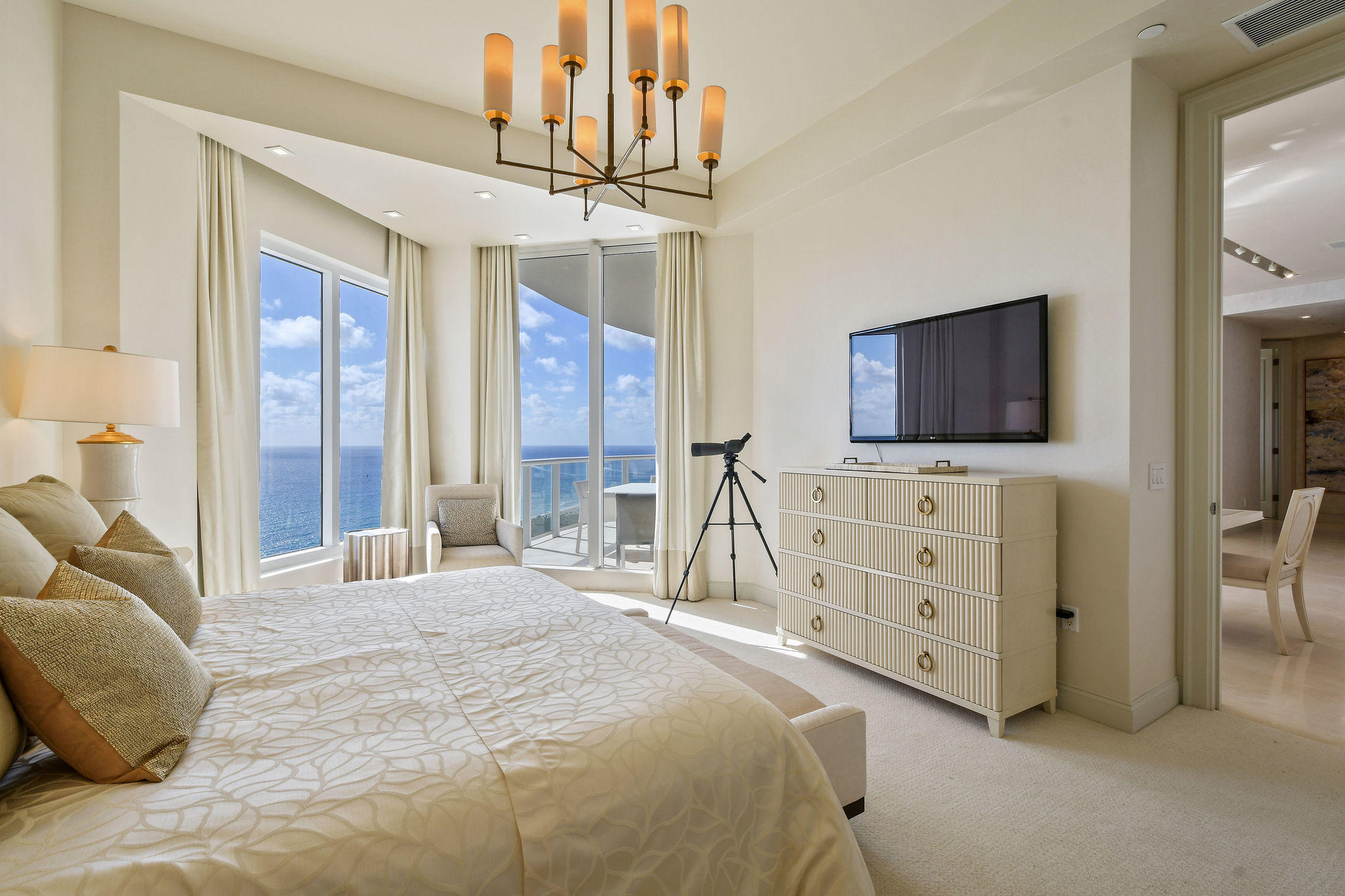 2700 North Ocean Drive, Unit LPH4B Riviera Beach, FL 33404 - Photo 17 of 67 a bedroom with a bed a flat screen tv and a dresser