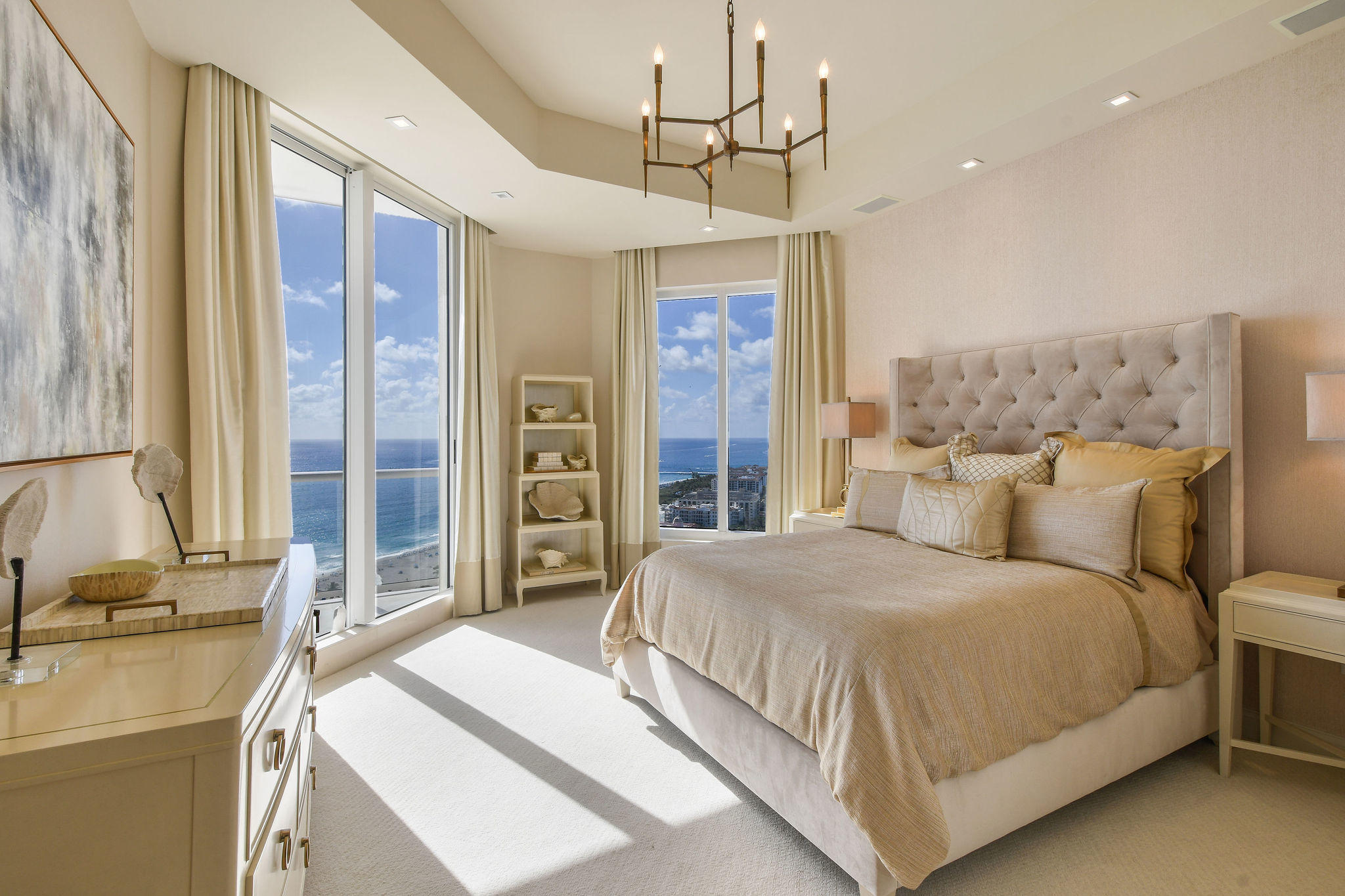 2700 North Ocean Drive, Unit LPH4B Riviera Beach, FL 33404 - Photo 22 of 67 a bedroom with a large bed and a chandelier
