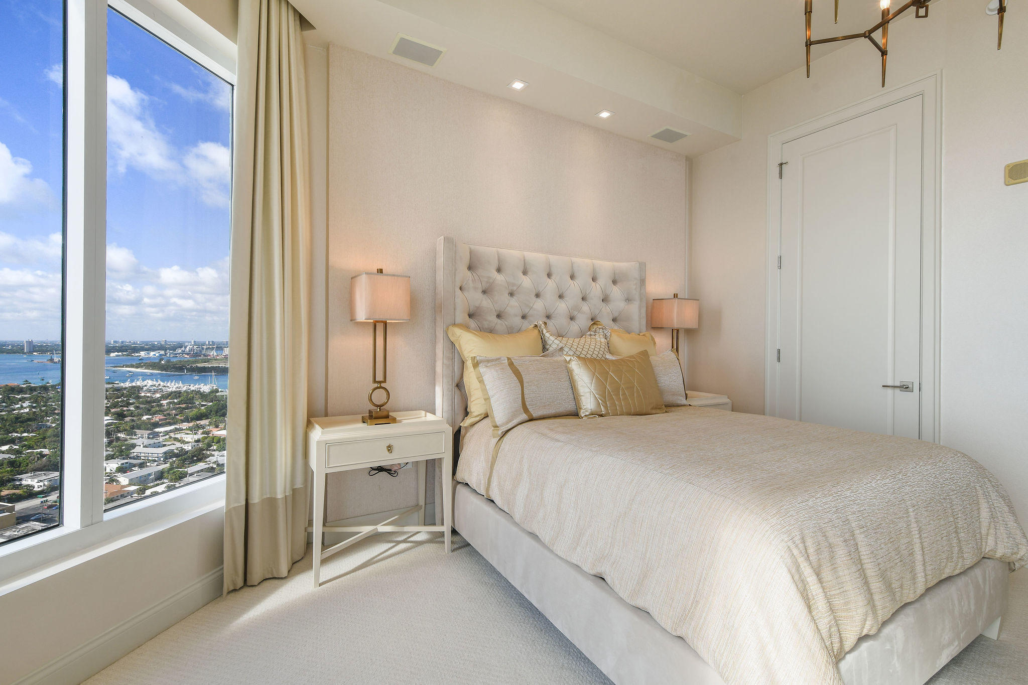 2700 North Ocean Drive, Unit LPH4B Riviera Beach, FL 33404 - Photo 24 of 67 a bedroom with a bed and a large mirror next to a window