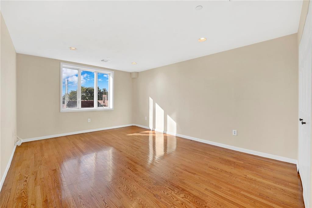52 92nd Street, Unit 7C Brooklyn, NY 11209 - Photo 12 of 22 a view of an empty room with wooden floor and a window