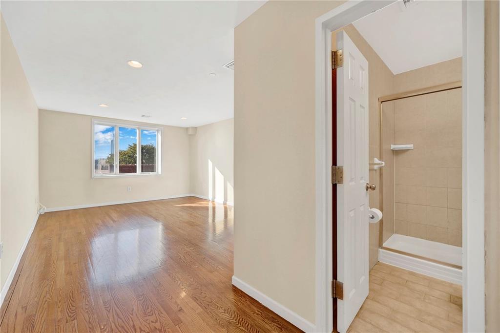 52 92nd Street, Unit 7C Brooklyn, NY 11209 - Photo 13 of 22 a view of an empty room with wooden floor and a window