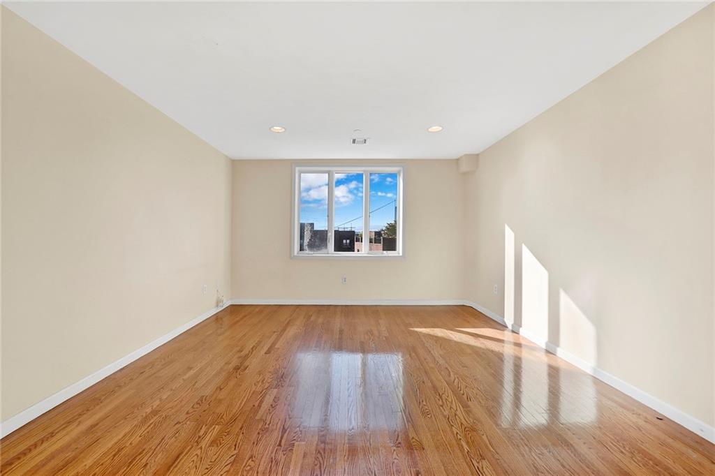 52 92nd Street, Unit 7C Brooklyn, NY 11209 - Photo 15 of 22 an empty room with wooden floor and windows