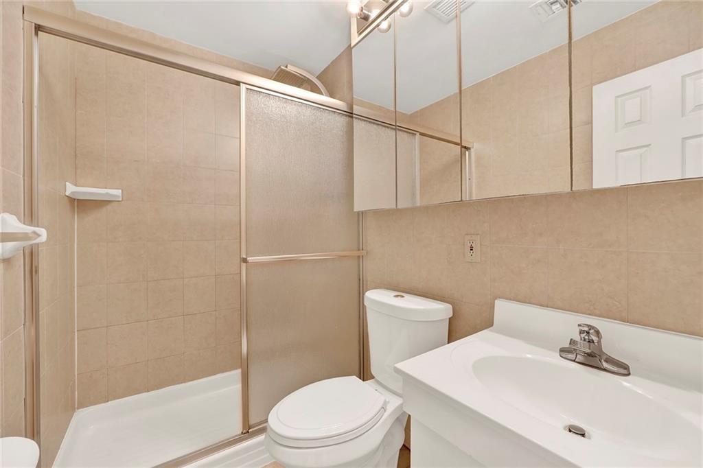 52 92nd Street, Unit 7C Brooklyn, NY 11209 - Photo 17 of 22 a white toilet sitting next to a bathroom sink