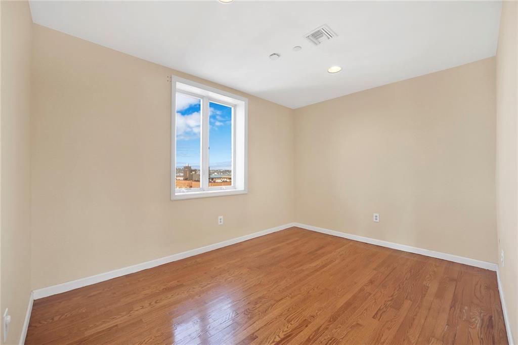 52 92nd Street, Unit 7C Brooklyn, NY 11209 - Photo 18 of 22 a view of empty room with wooden floor and fan