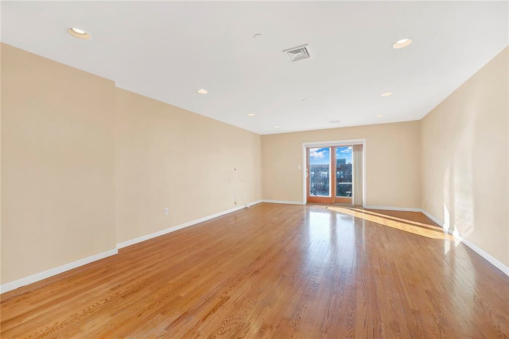 52 92nd Street, Unit 7C Brooklyn, NY 11209 - Photo 19 of 22 a view of an empty room with wooden floor and window