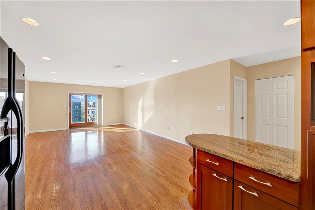 52 92nd Street, Unit 7C Brooklyn, NY 11209 - Photo 3 of 22 a view of an empty room with wooden floor and a window