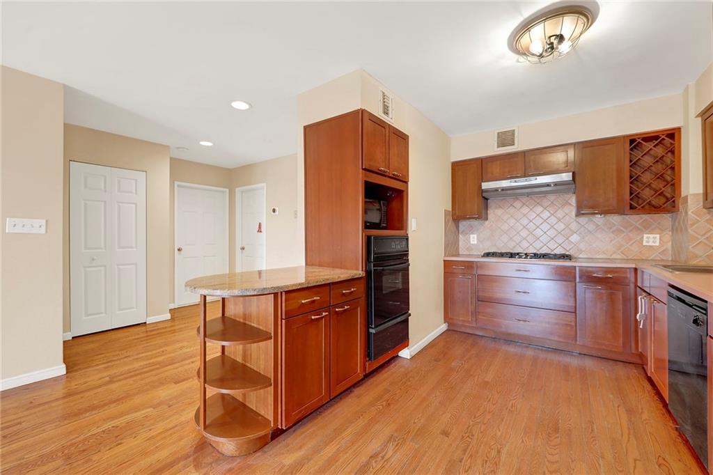 52 92nd Street, Unit 7C Brooklyn, NY 11209 - Photo 4 of 22 a kitchen with stainless steel appliances granite countertop a refrigerator and a stove top oven