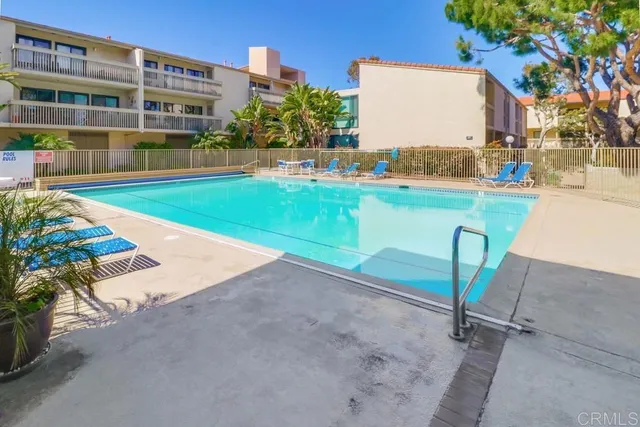 a backyard of a house with a garden and outdoor seating
