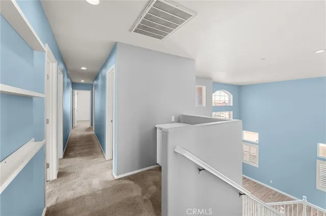 a view of hallway with window and stairs