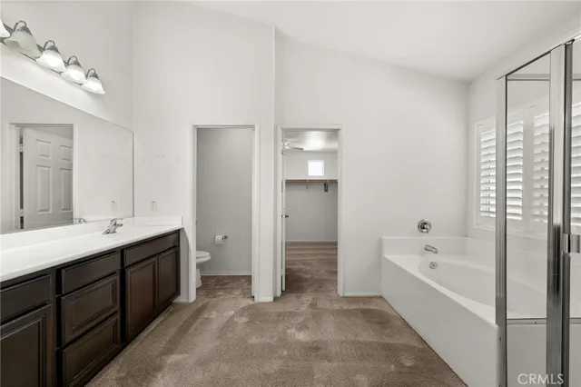 a spacious bathroom with a bathtub sink and mirror