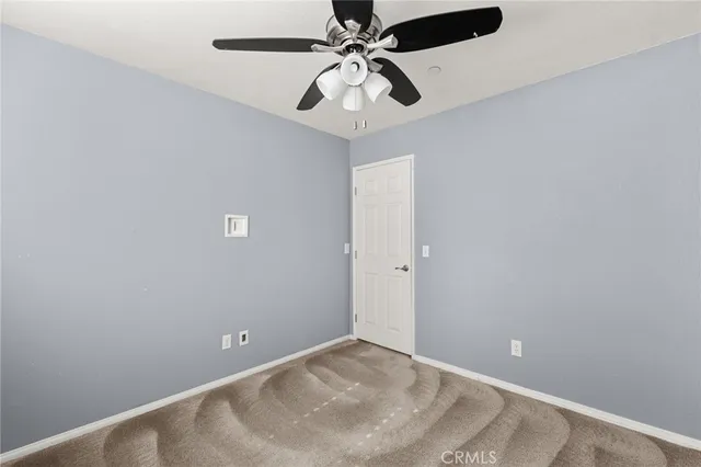 a view of a chandelier fan and entryway