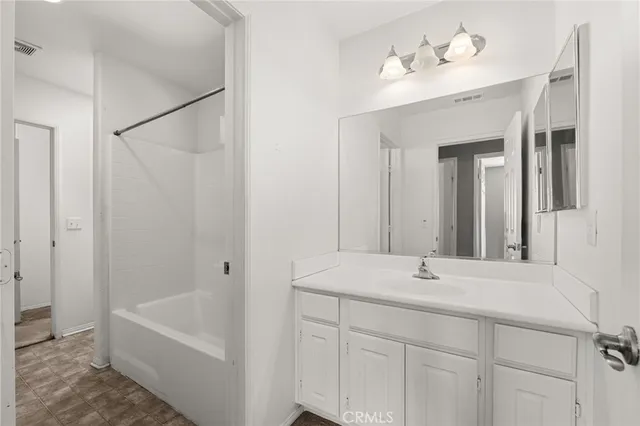 a bathroom with a tub sink and mirror