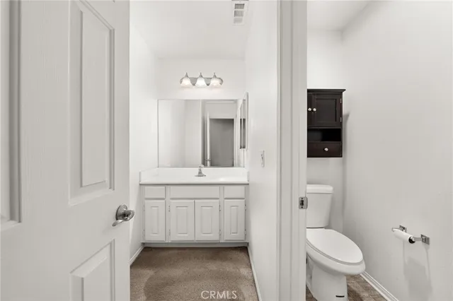 a spacious bathroom with a toilet sink and mirror