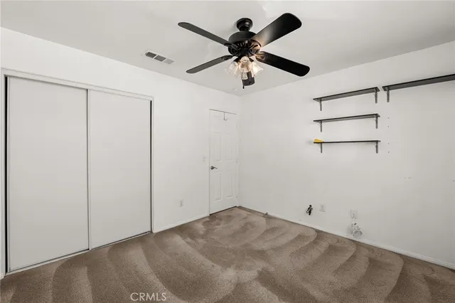 a view of a big room with a ceiling fan