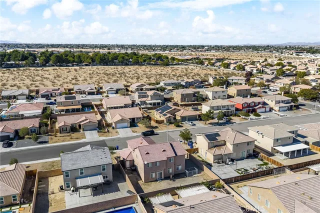 an aerial view of a city with lots of residential buildings and lake view