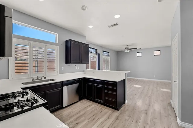 a kitchen with stainless steel appliances a sink stove and cabinets