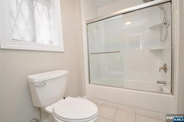 a white toilet sitting next to a bath tub shower