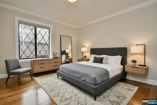 a bedroom with a bed and a large window