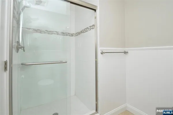 a bathroom with a glass shower door
