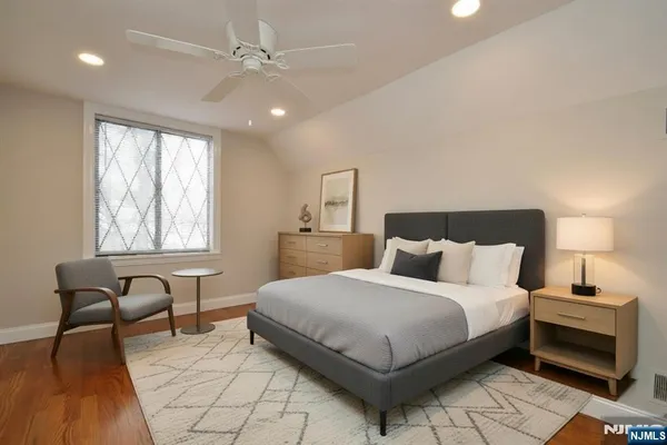 a bedroom with a bed and a chair