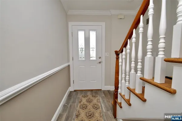 a view of an entryway with wooden floor and door