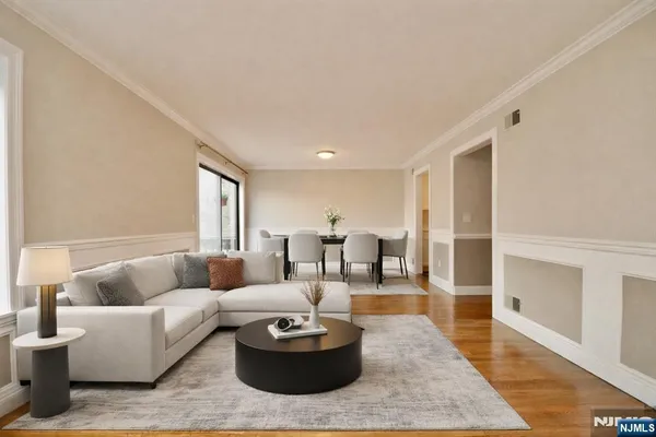 a living room with furniture and view of kitchen