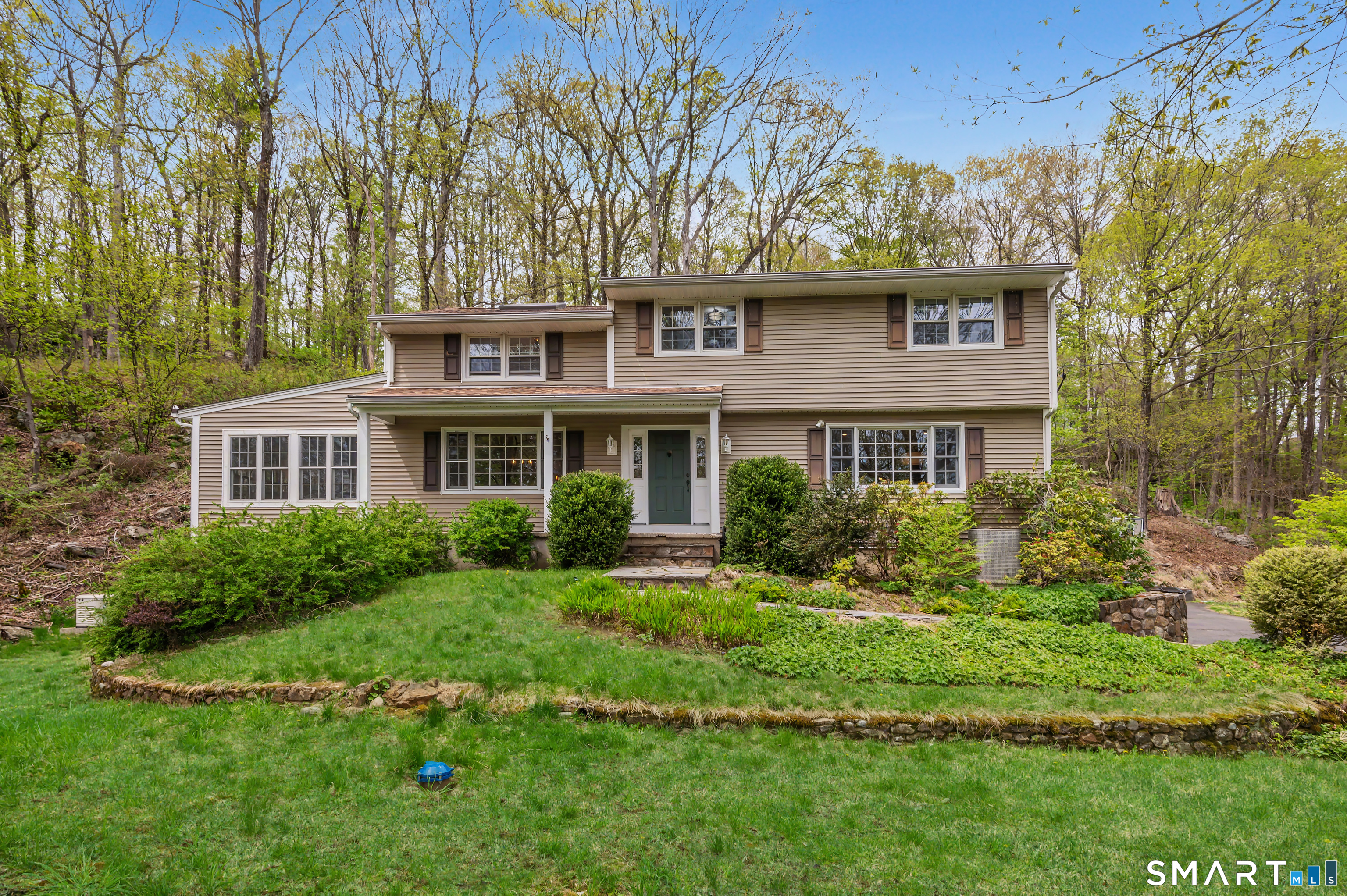 16 Twixt Hills Road Ridgefield, CT 06877 - Photo 1 of 25 a front view of a house with a yard