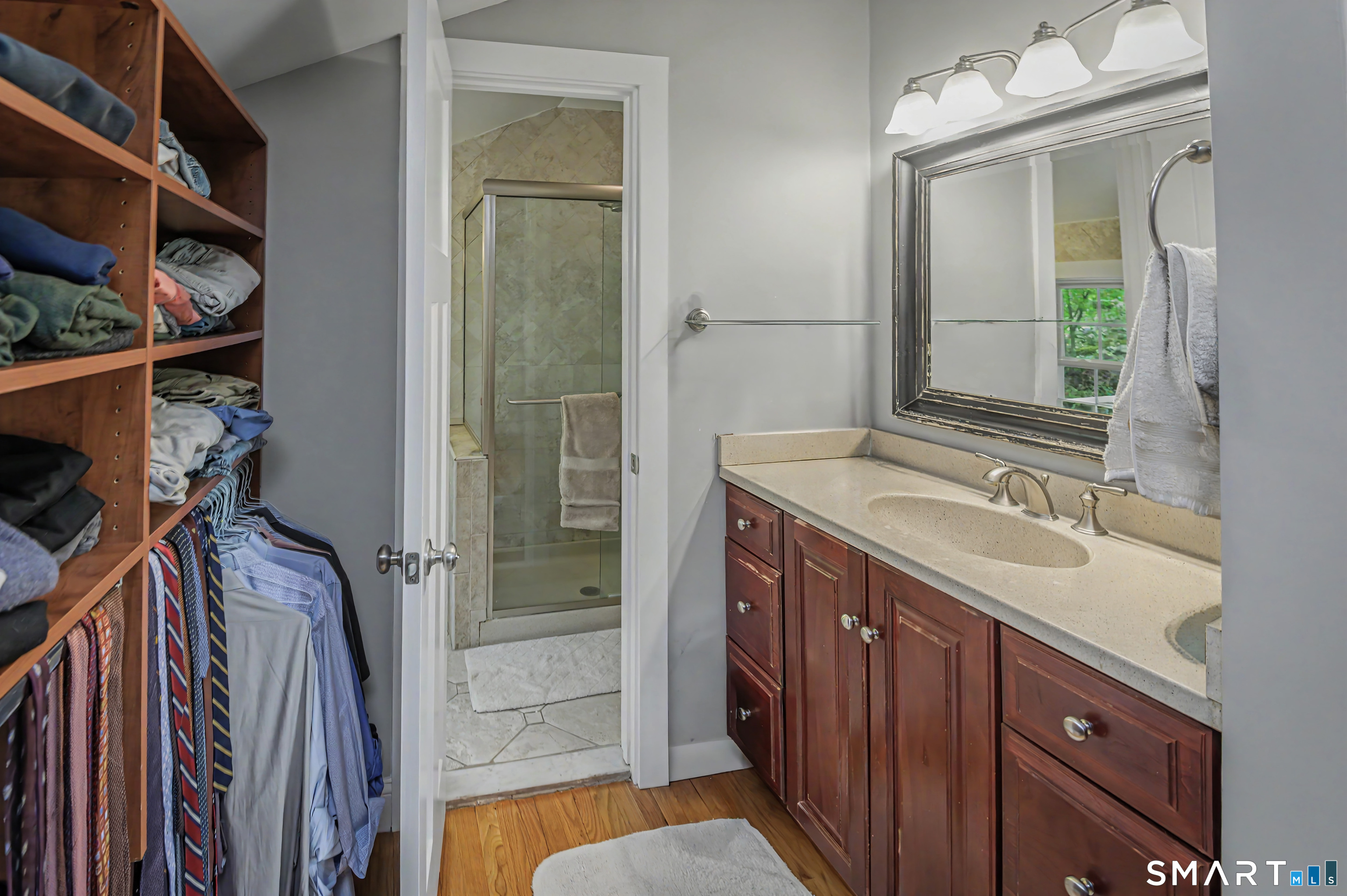 16 Twixt Hills Road Ridgefield, CT 06877 - Photo 16 of 25 a bathroom with a sink a mirror and a shower