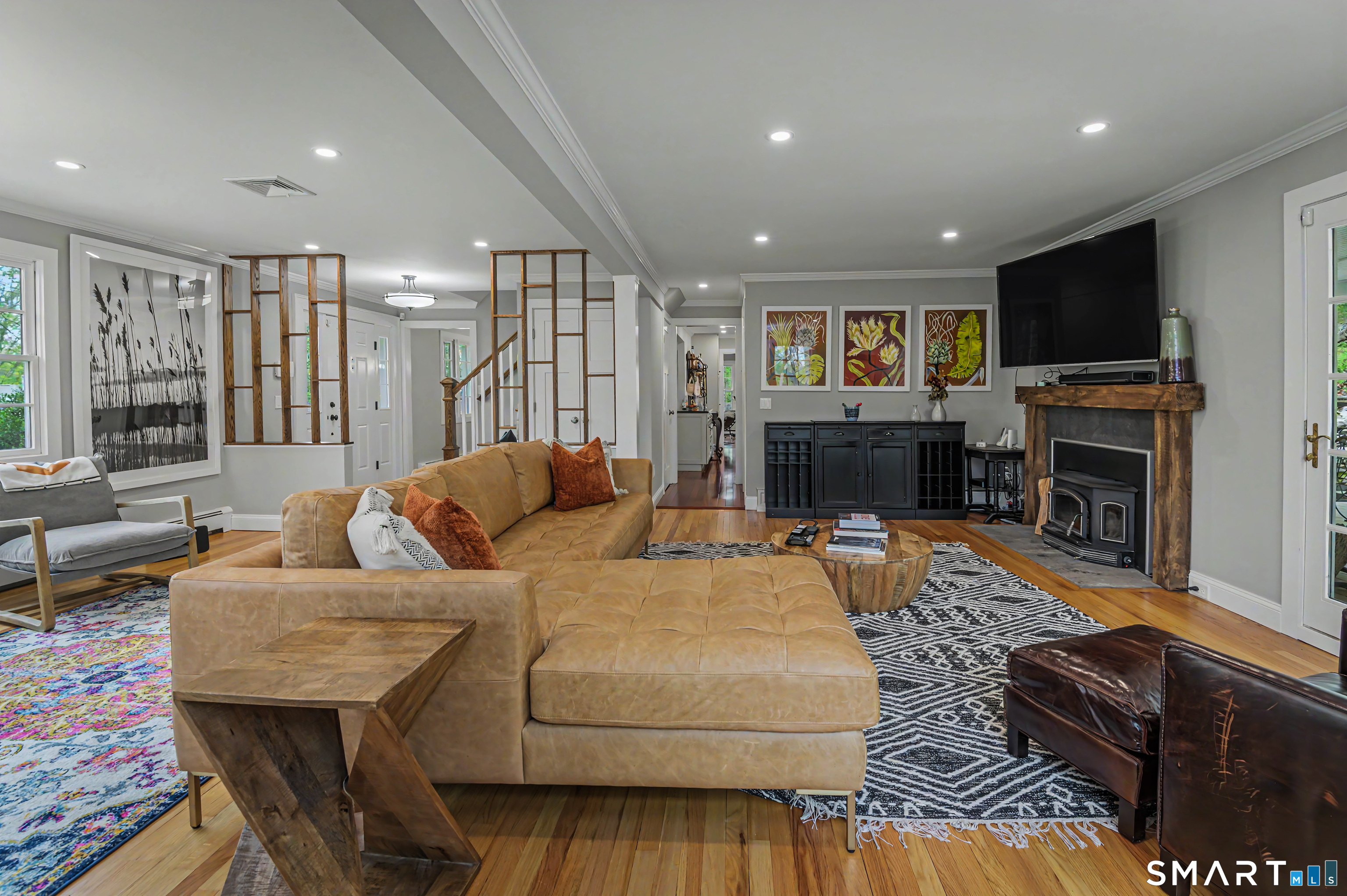 16 Twixt Hills Road Ridgefield, CT 06877 - Photo 3 of 25 a living room with fireplace furniture and a flat screen tv