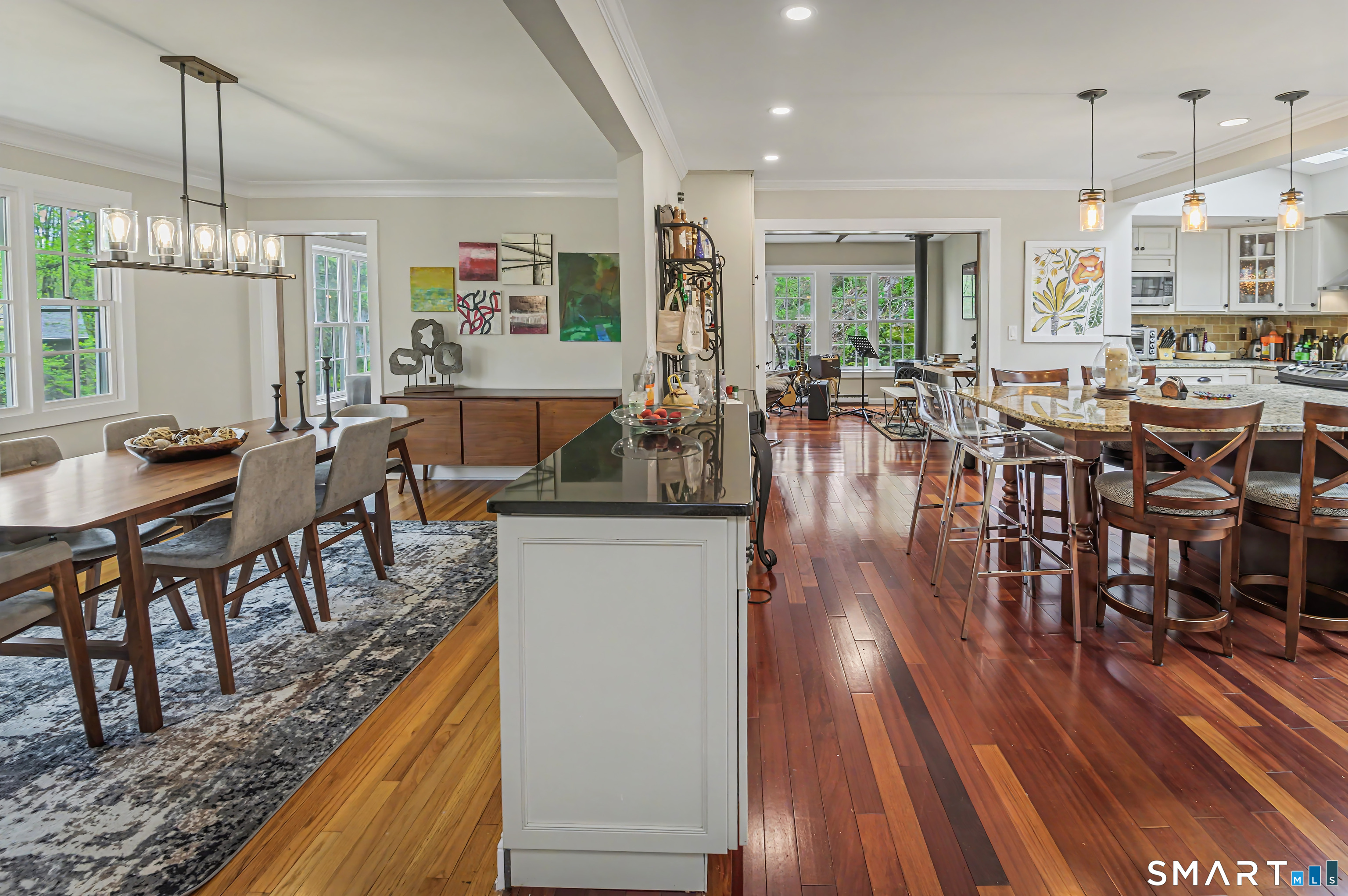 16 Twixt Hills Road Ridgefield, CT 06877 - Photo 6 of 25 a view of a dining room and livingroom with furniture wooden floor a chandelier