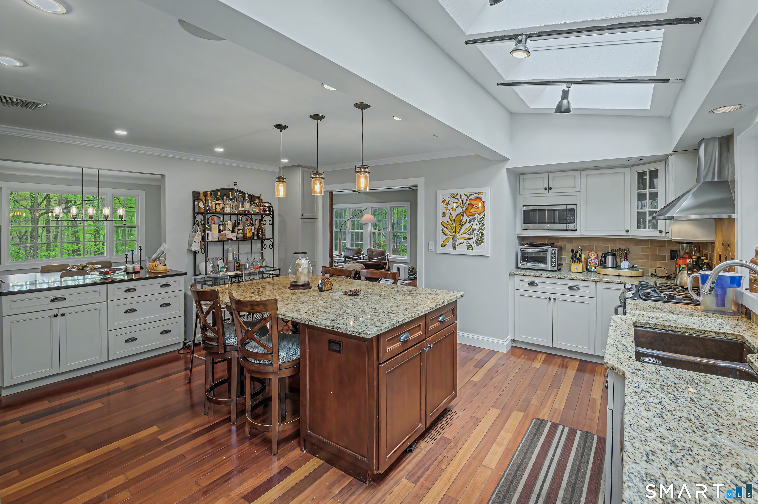 16 Twixt Hills Road Ridgefield, CT 06877 - Photo 8 of 25 a kitchen with stainless steel appliances granite countertop a stove oven a refrigerator cabinets and wooden floor