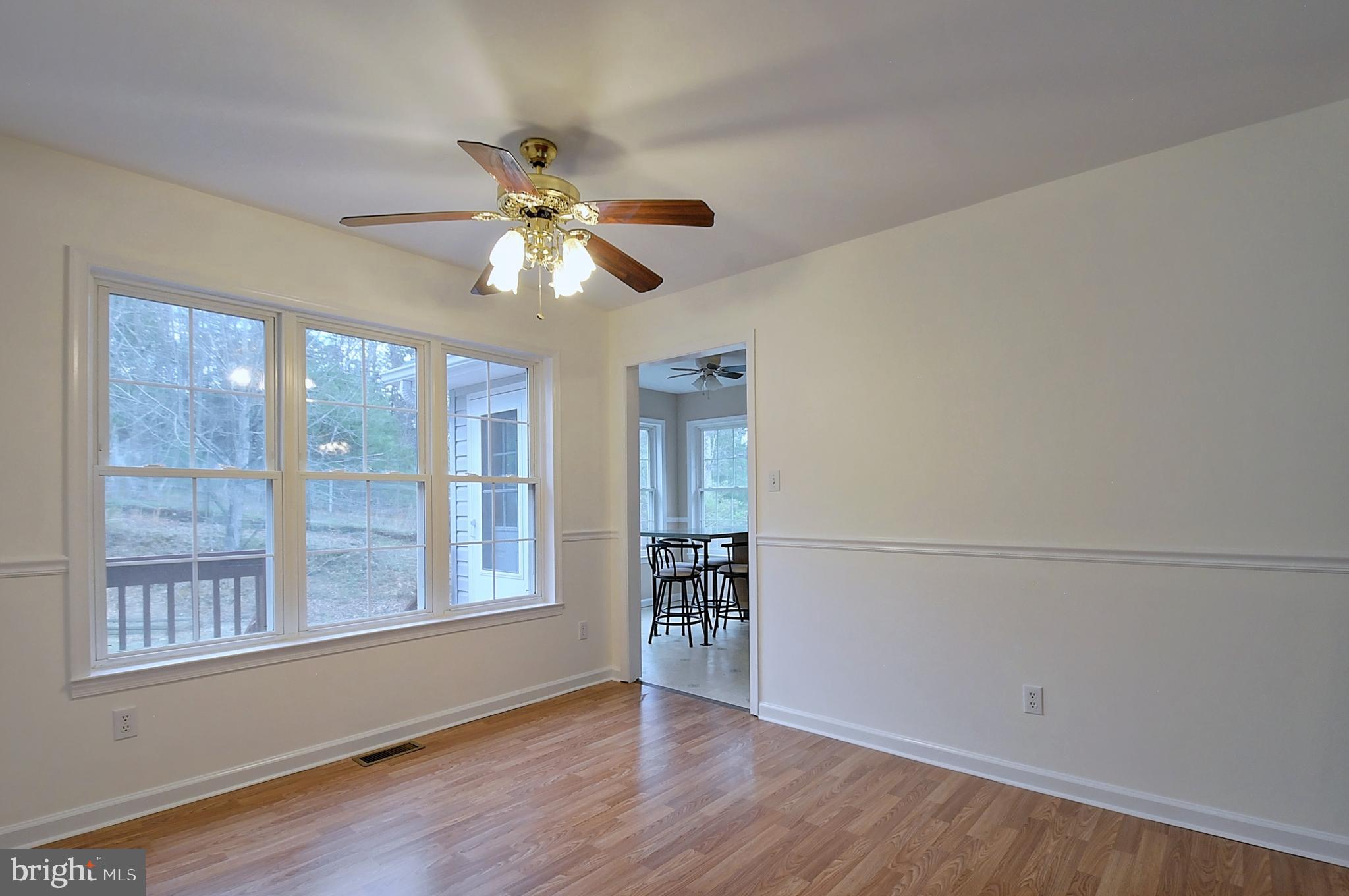 235 Peppermint Spring Lane Winchester, VA 22603 - Photo 41 of 90 a view of an empty room with a window and wooden floor