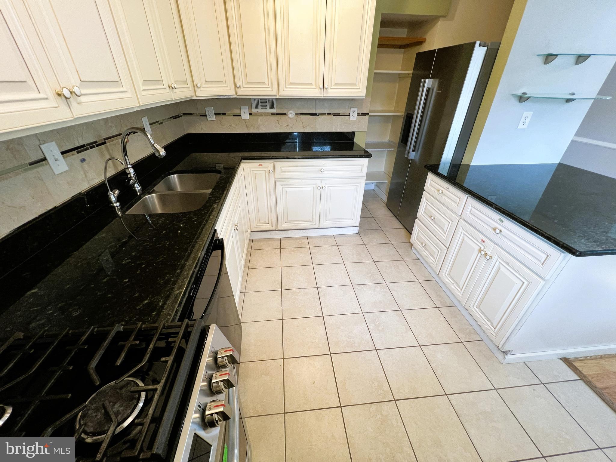 3705 Bancroft Road Baltimore, MD 21215 - Photo 9 of 50 a kitchen with a sink and a stove top oven