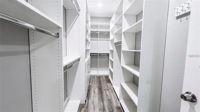 a view of walk in closet with empty racks