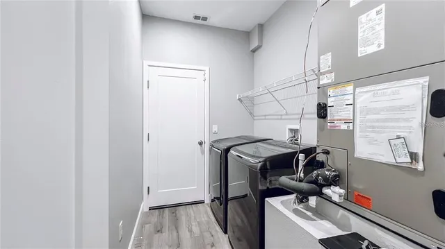 a view of storage and utility room with washer and dryer