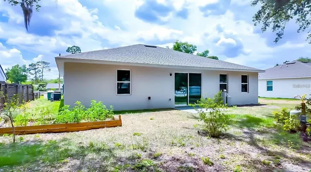 a front view of house with yard and trees around
