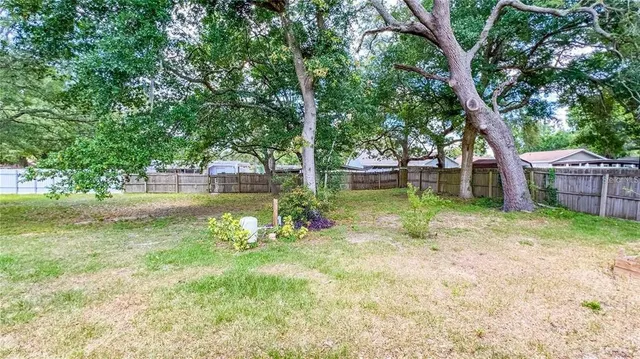 a backyard of a house with lots of green space and fountain