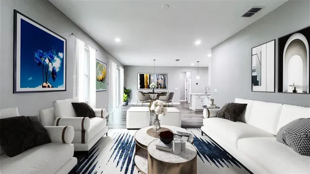 a living room with furniture and a wooden floor