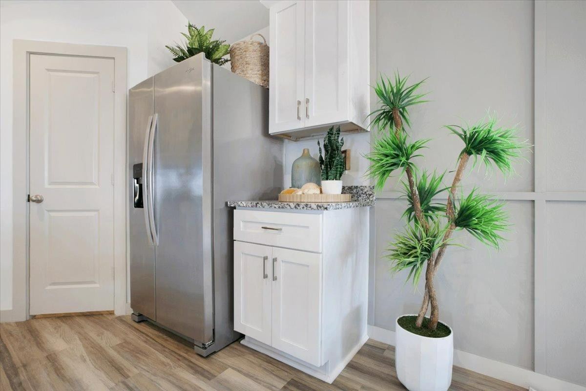 7415 8th Street Lubbock, TX 79416 - Photo 12 of 22 a white refrigerator freezer sitting inside of a kitchen