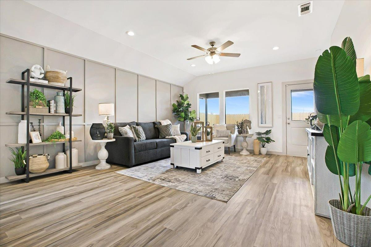 7415 8th Street Lubbock, TX 79416 - Photo 15 of 22 a living room with furniture and a chandelier