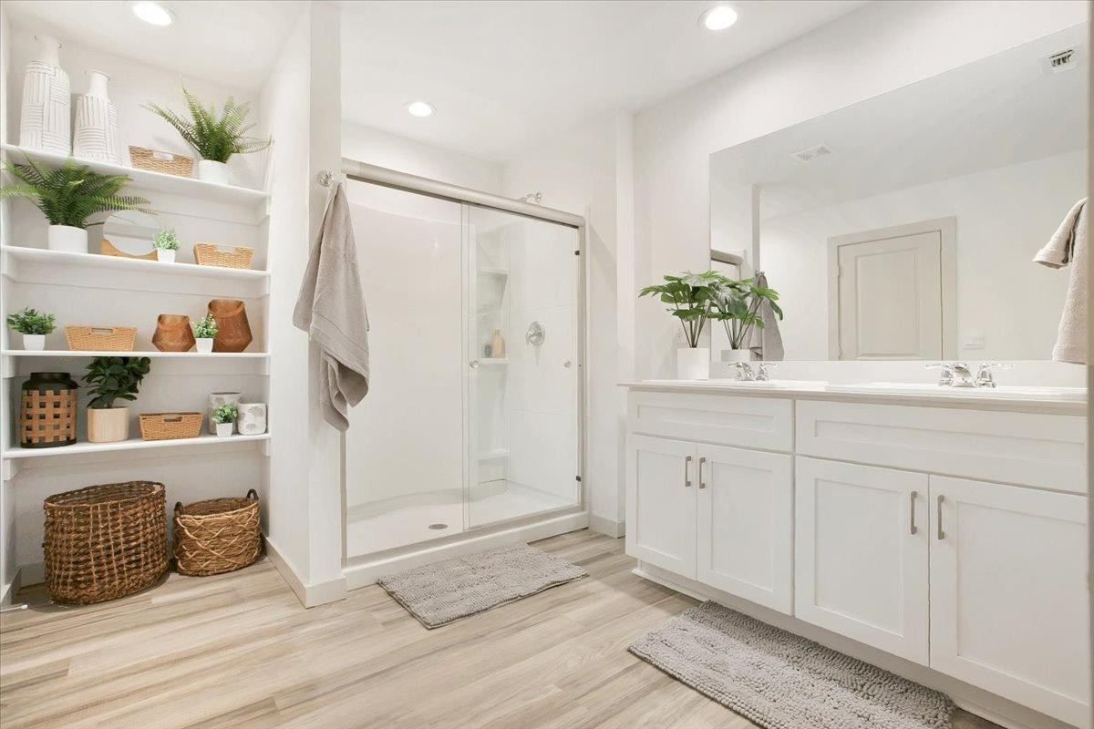 7415 8th Street Lubbock, TX 79416 - Photo 17 of 22 a bathroom with a double vanity sink and shower